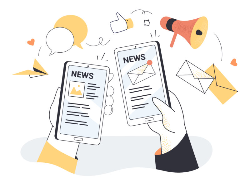 hand holding smartphone with online newspaper